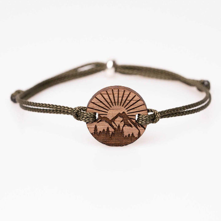 Rundes Nussbaumholz-Armband mit detailreicher Gravur von Bergen, Wald und Sonnenstrahlen, olivgrünes Nylonband, personalisiertes Naturarmband als Geschenk für Outdoor-Begeisterte