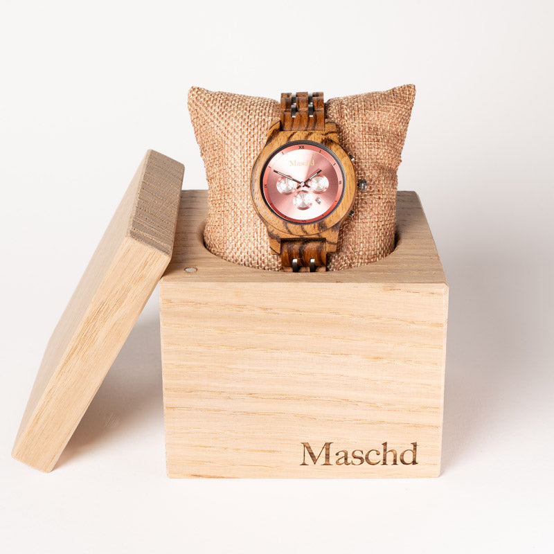Frauen Holzuhr aus zebrano mit Pinken ziffernblatt in einer eichenwürfel verpackung 