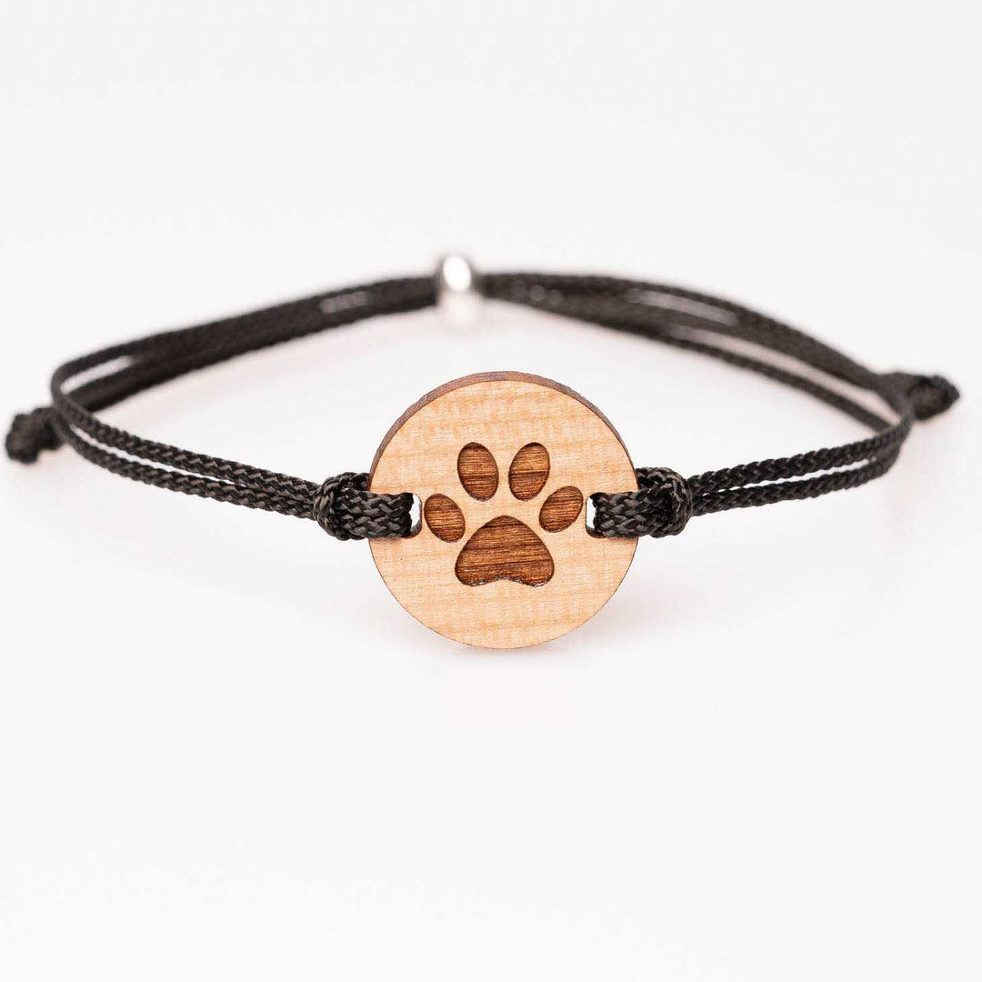 Kirschholz-Armband mit detailreicher Pfote, schwarzes Nylonband, personalisierbarer Holzschmuck – individuelles Accessoire und liebevolle Geschenkidee für Haustierbesitzer